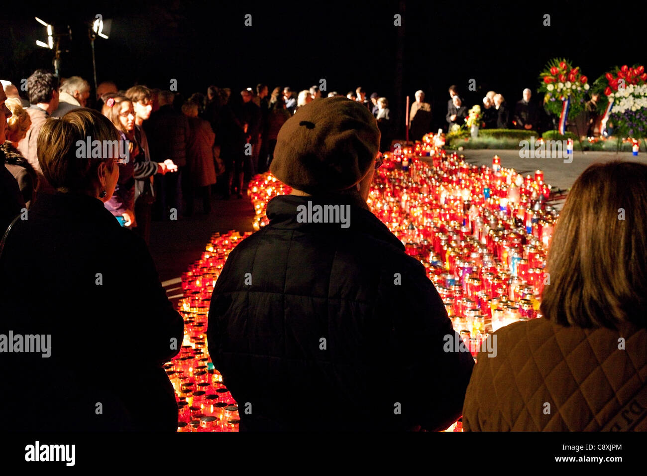 People are standing and praying in front of Franjo Tudman's grave on All Saints' day. Stock Photo