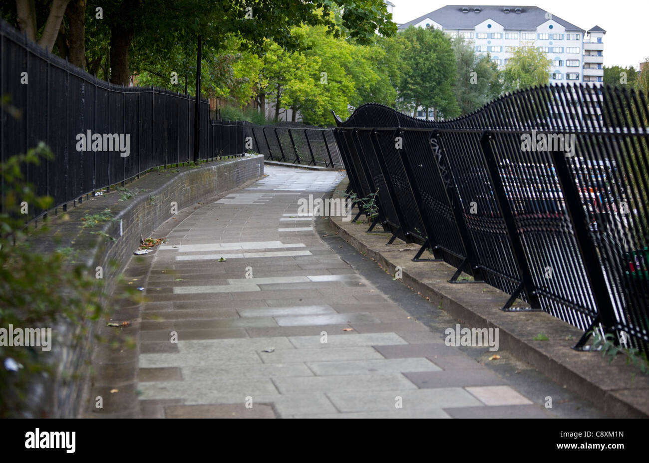 Paved walking path and railings, UK Stock Photo