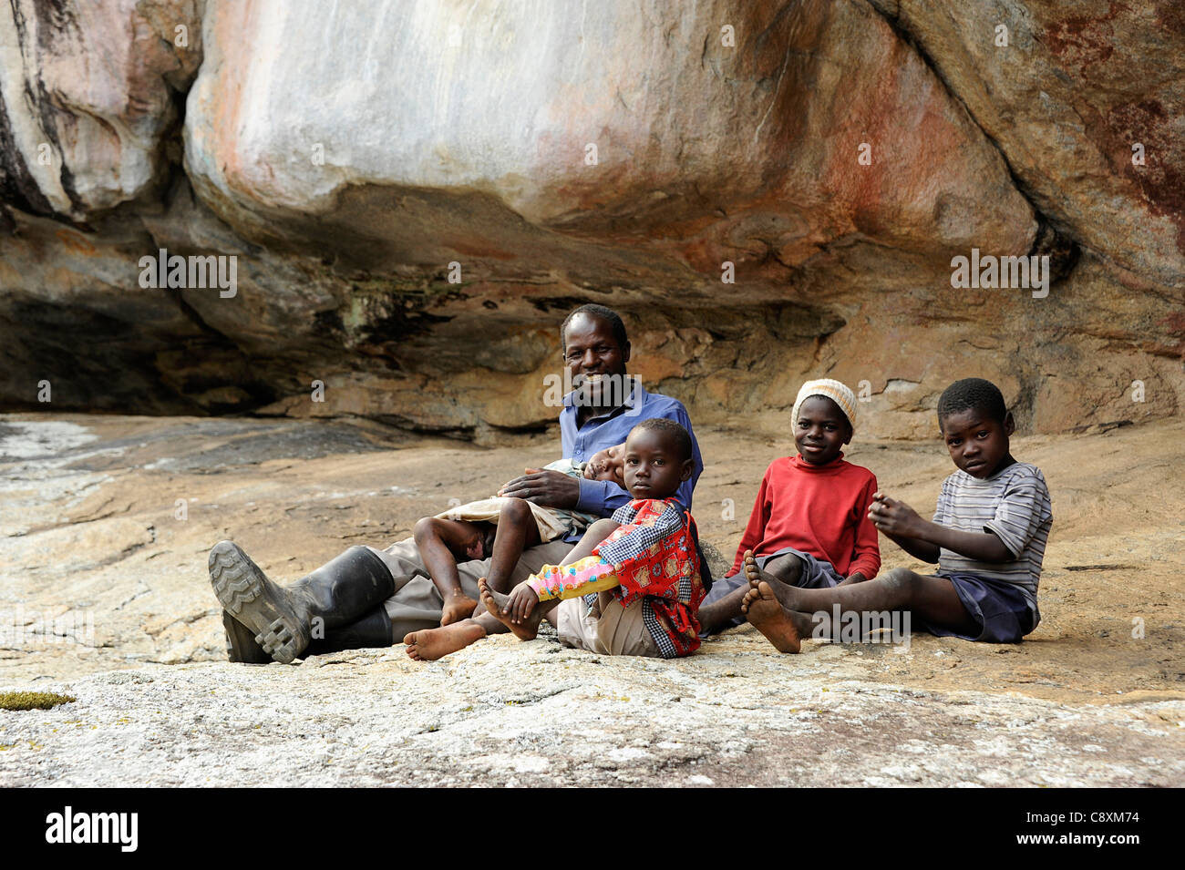 Zimbabwean family in Markwe Cave, Ismire, Zimbabwe Stock Photo