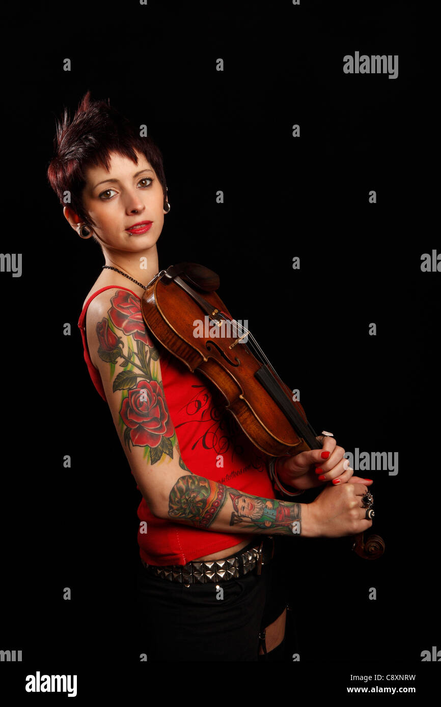 female violinist with tattoos on her arm Stock Photo