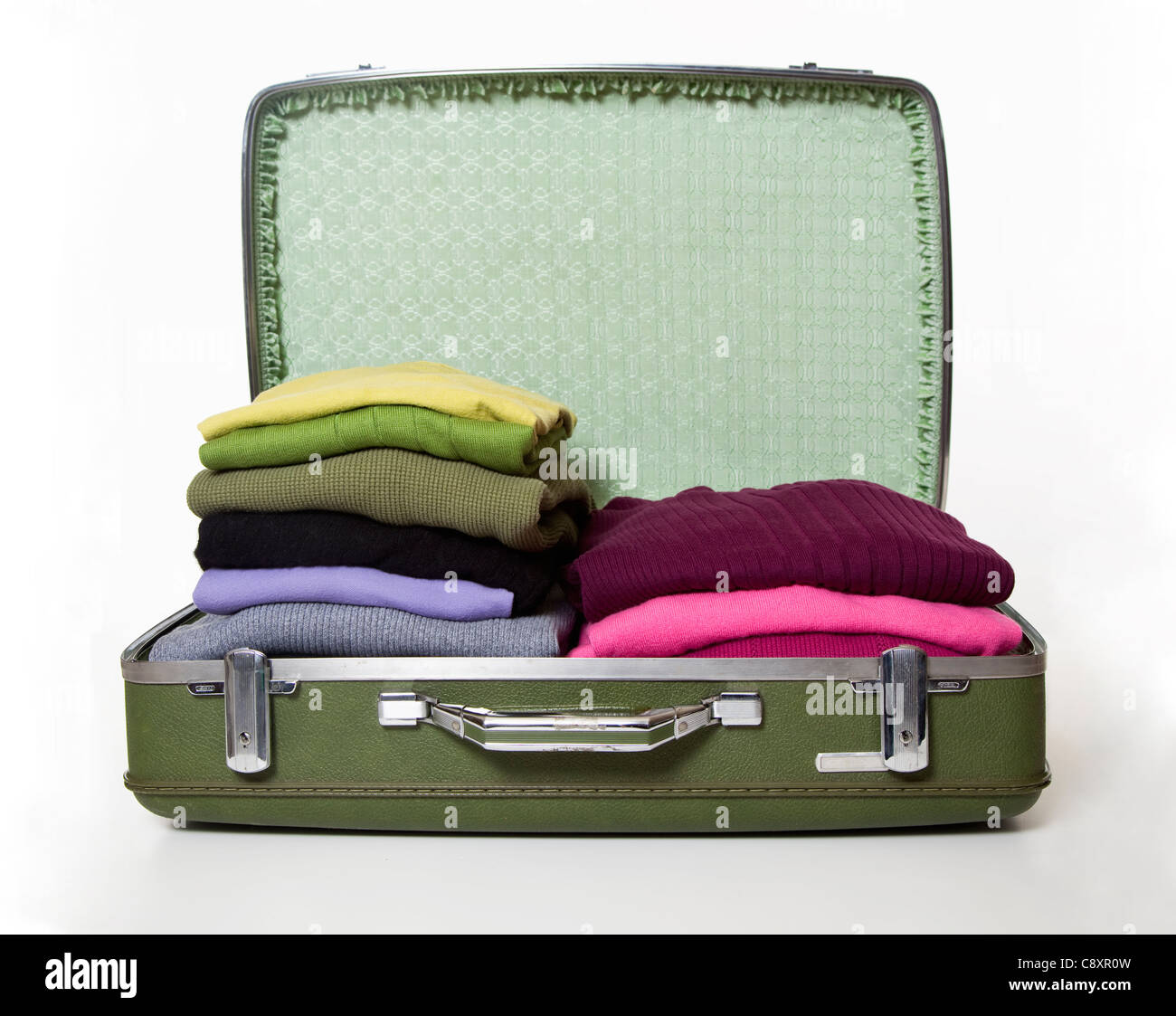 Open suitcase with cloths, studio shot Stock Photo