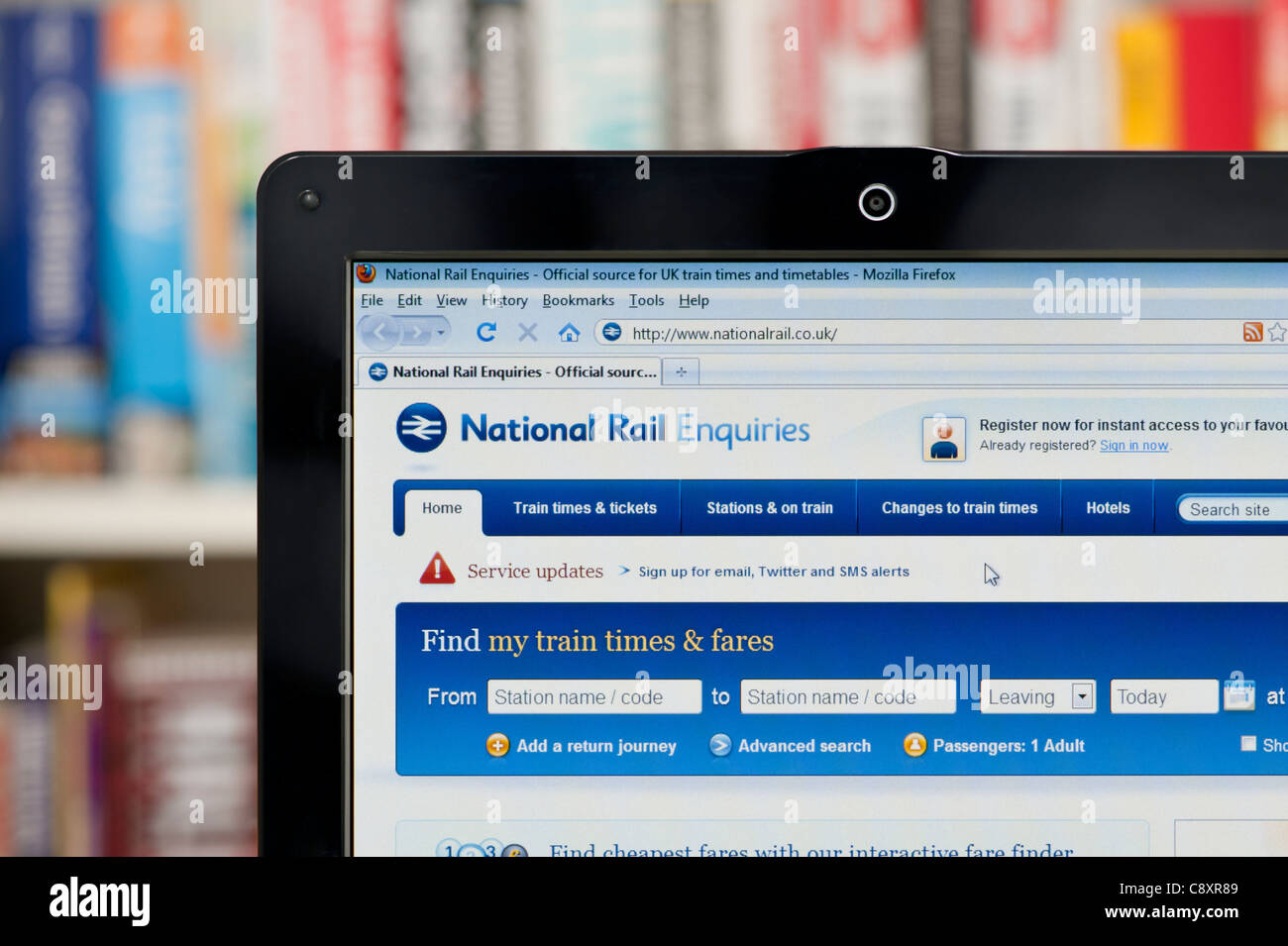 The National Rail website shot against a bookcase background (Editorial use only: print, TV, e-book and editorial website). Stock Photo
