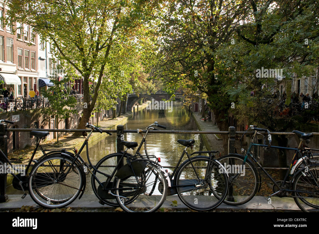 Bikes resting on the side of a canal in the Netherlands Stock Photo