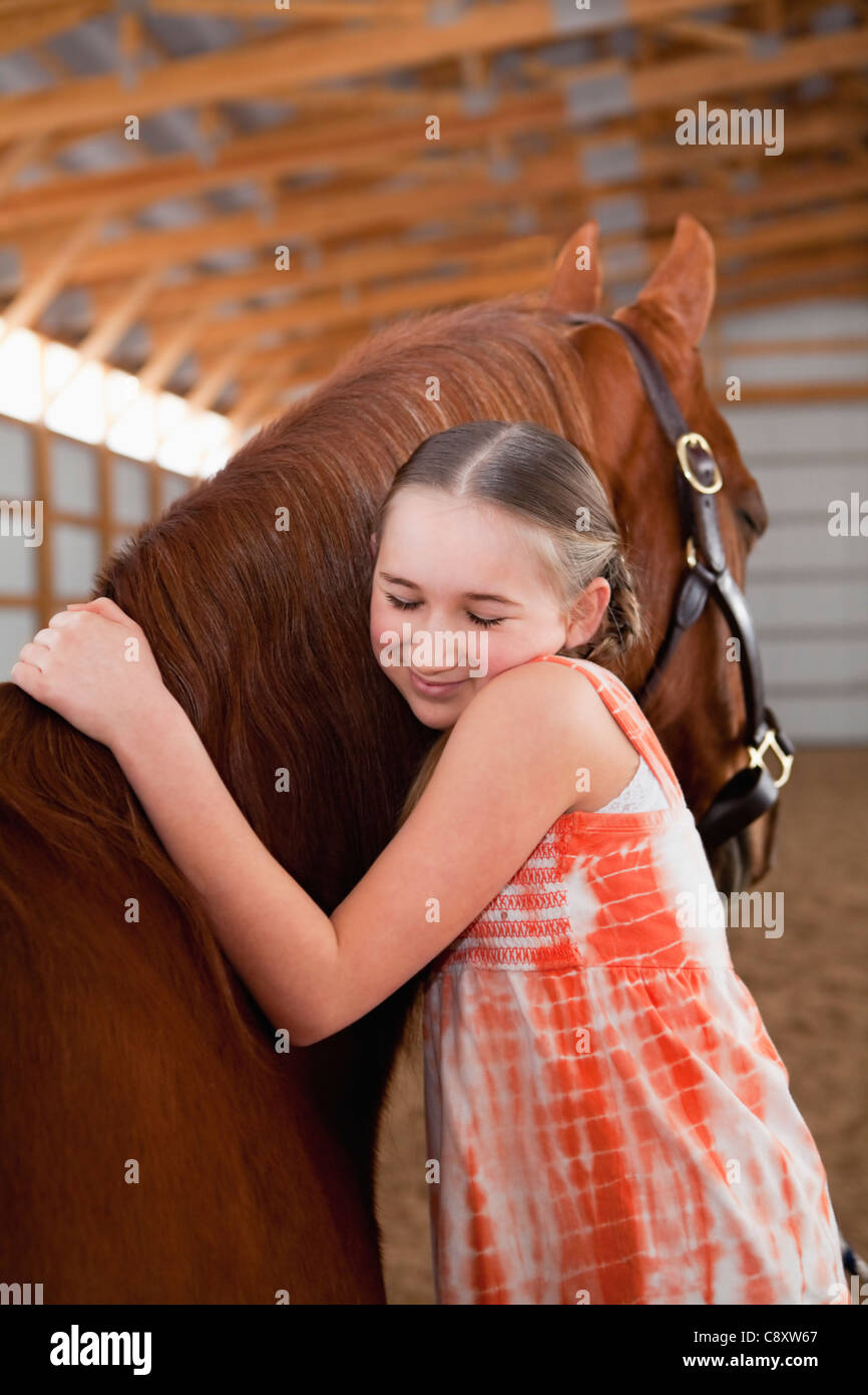 USA, Illinois, Metamora, Portrait of girl (1011) embracing horse Stock