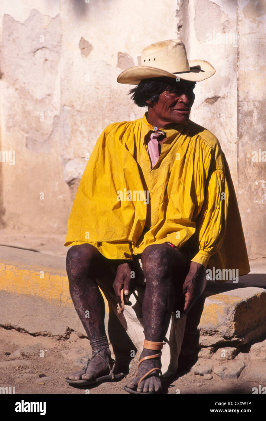 Tarahumara man lacing his sandals in Batopilas, Copper Canyon region of Mexico Stock Photo