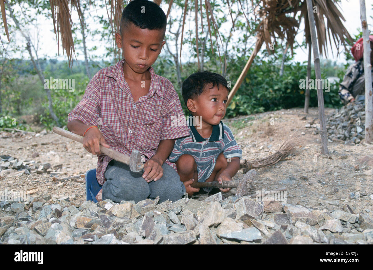 Child labourers work in a quarry breaking stones to build roads. Takeo ...