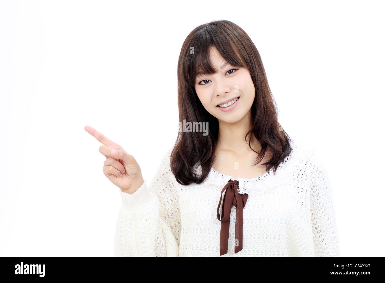 Smiling asian woman rise hand and pointing copy space Stock Photo - Alamy