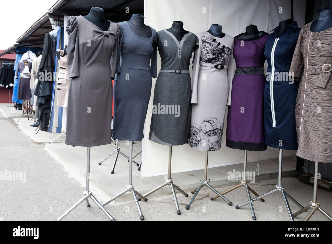 Woman dresses displayed outside stand at the market place in Poland Stock Photo