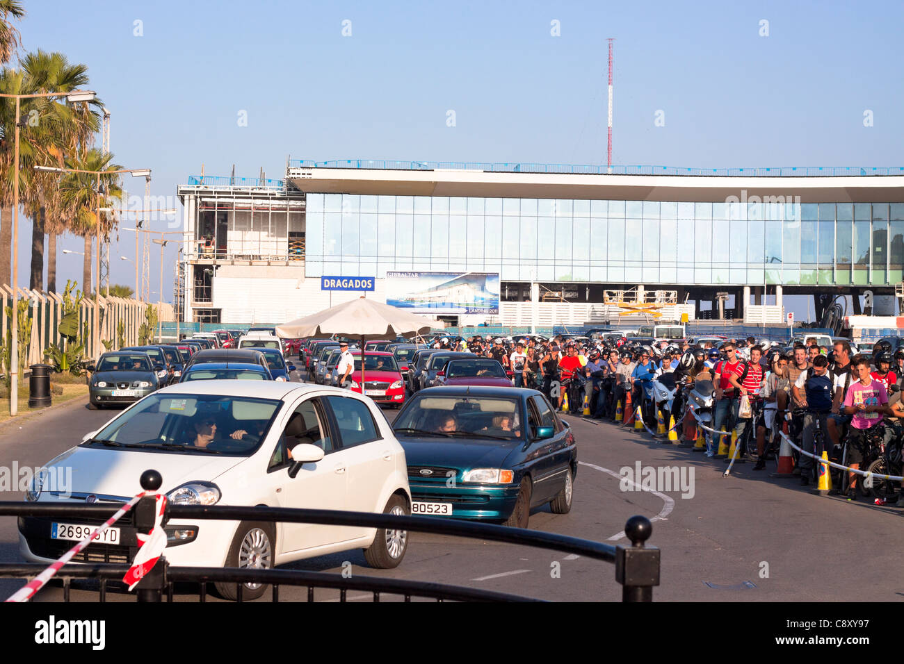 People waiting to cross border from Gibraltar to Spain next to the Gibraltar Airport new building during construction. Stock Photo