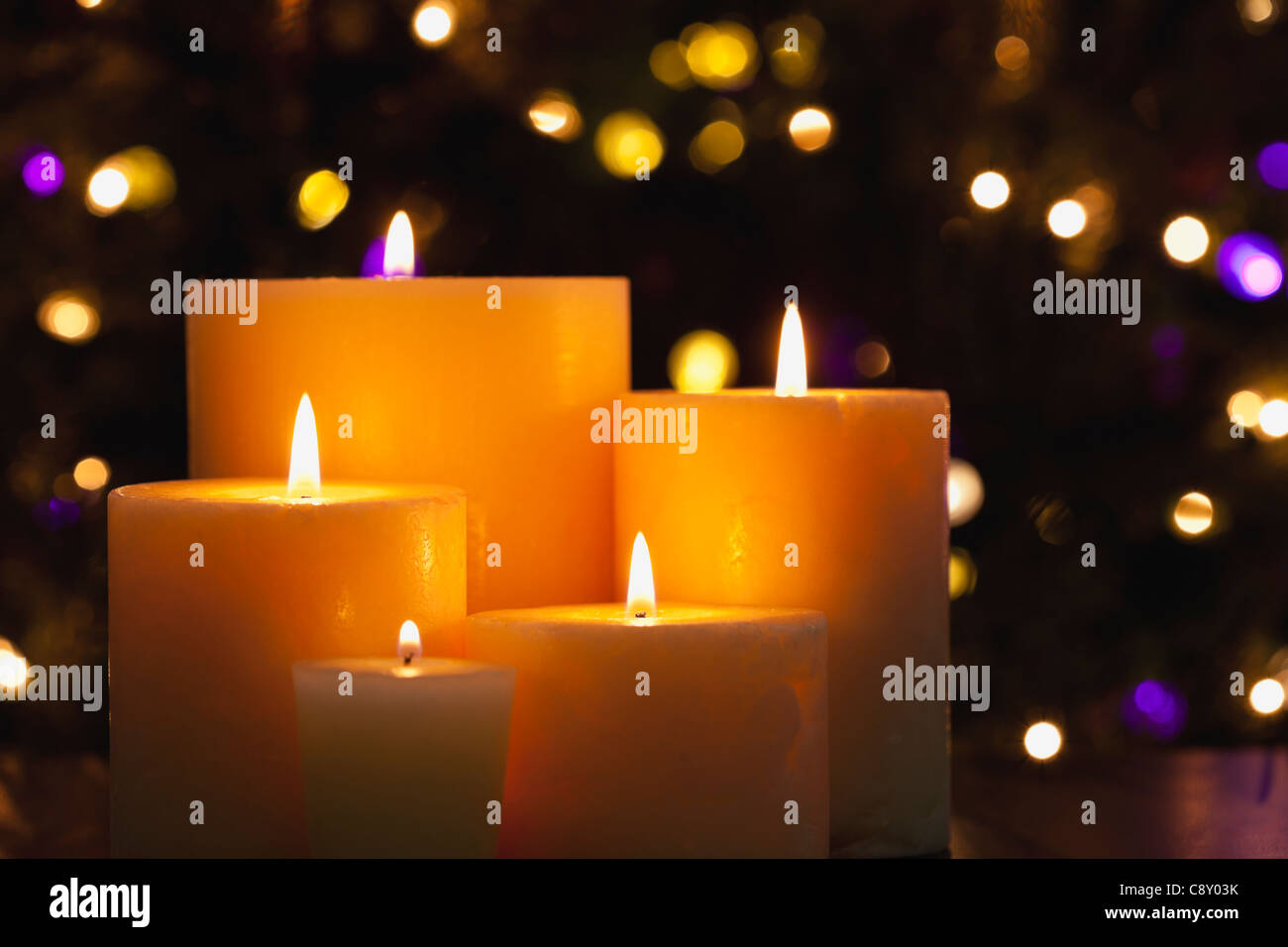USA, Illinois, Metamora, Close up of burning candles and Christmas lights in background Stock Photo