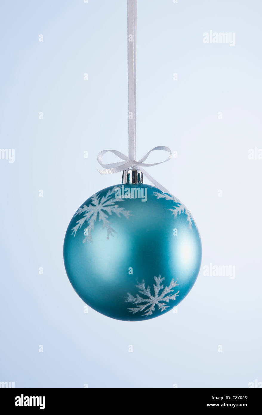 Studio shot of blue Christmas ornament hanging on ribbon Stock Photo