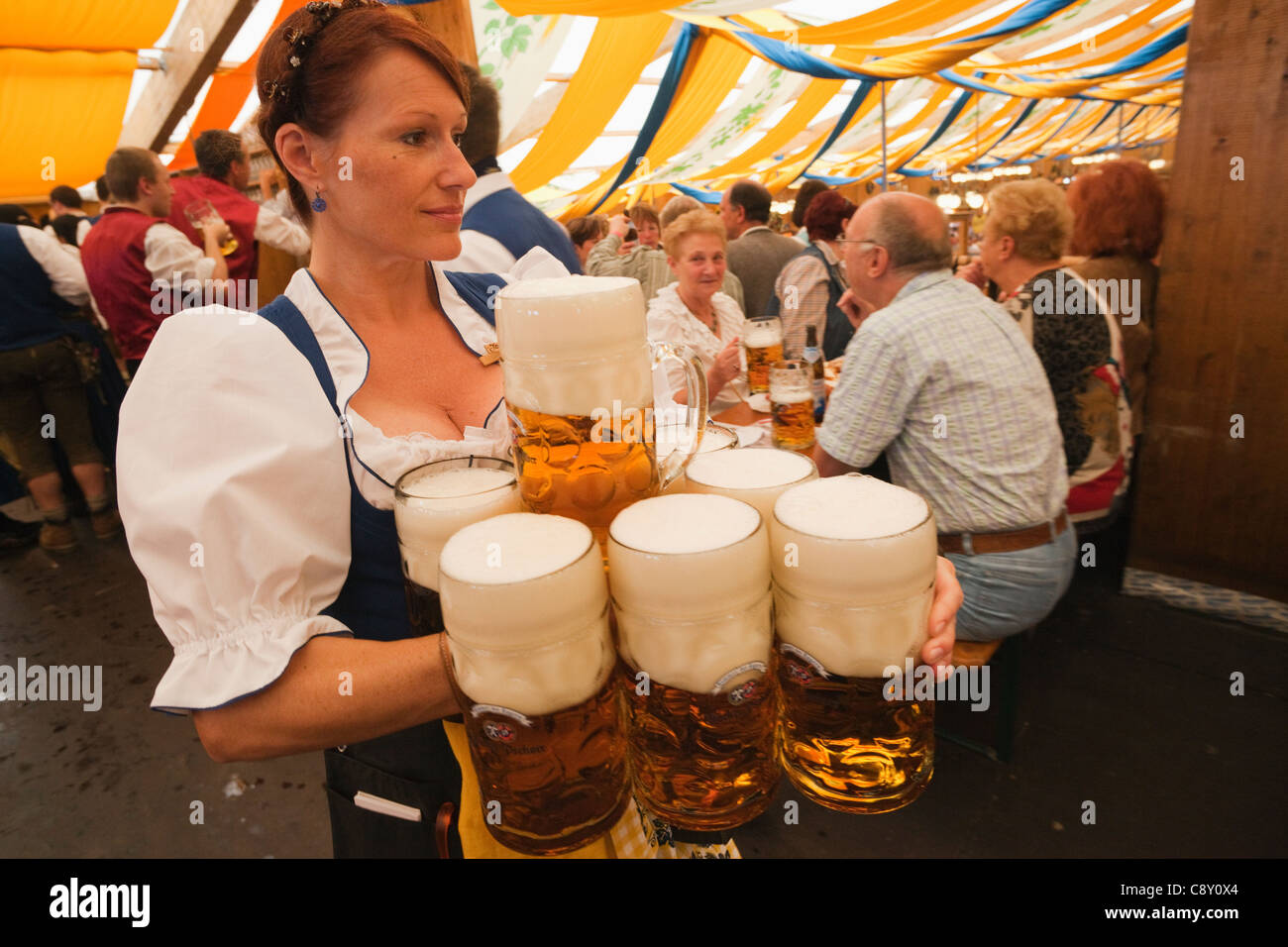 Germany, Bavaria, Munich, Oktoberfest, Waitress Holding Beer Steins