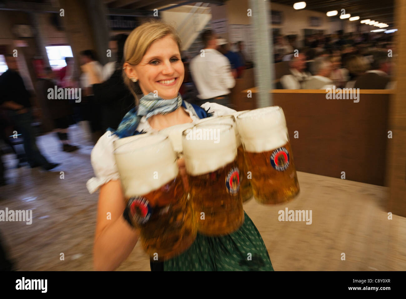 Germany, Bavaria, Munich, Oktoberfest, Waitress Holding Beer Steins ...