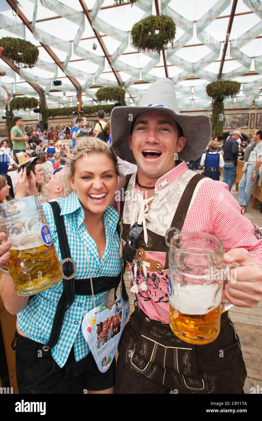 Germany, Bavaria, Munich, Oktoberfest, Couple in Bavarian Costume Drinking Beer Stock Photo