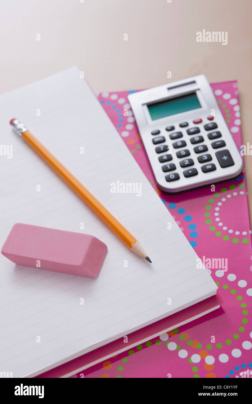 Pencil and calculator on notebook Stock Photo