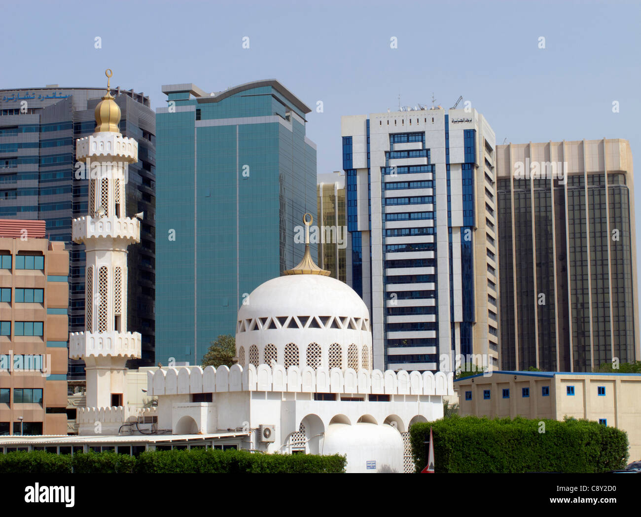 Contrast between mosque and new office buildings in central Abu Dhabi United Arab Emirates UAE Stock Photo