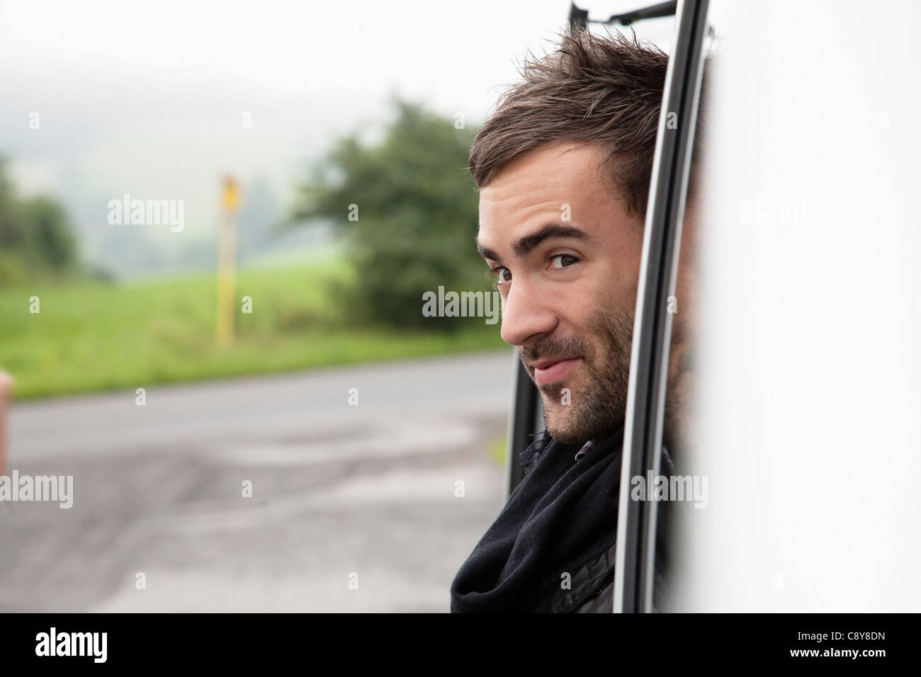 portrait of young man looking out of car window Stock Photo