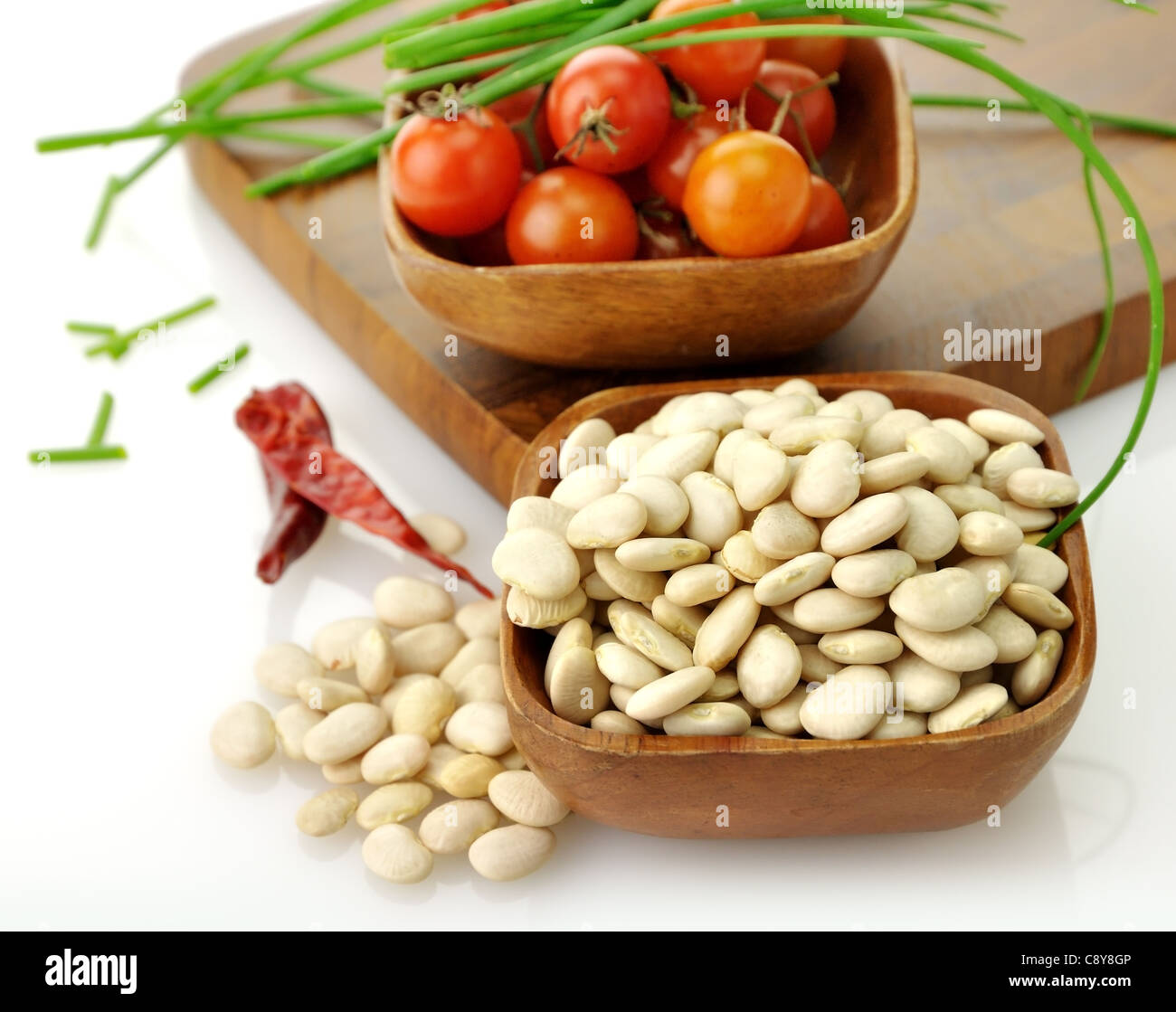 Baby Lima Beans , Tomatoes And Spices In Wooden Bowls Stock Photo