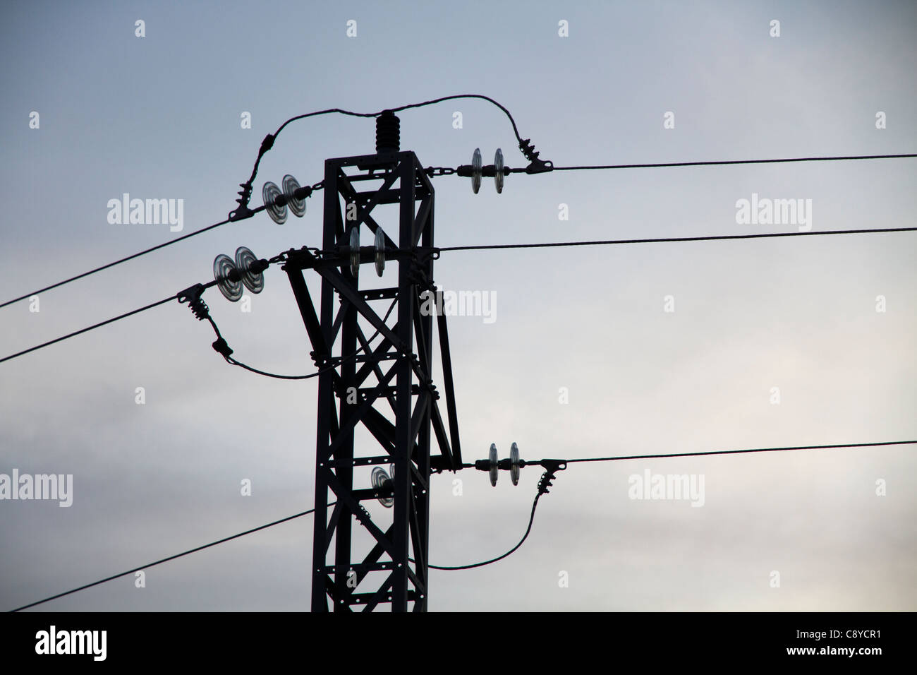 Electrical pylon and power lines on cloudy sky Stock Photo - Alamy