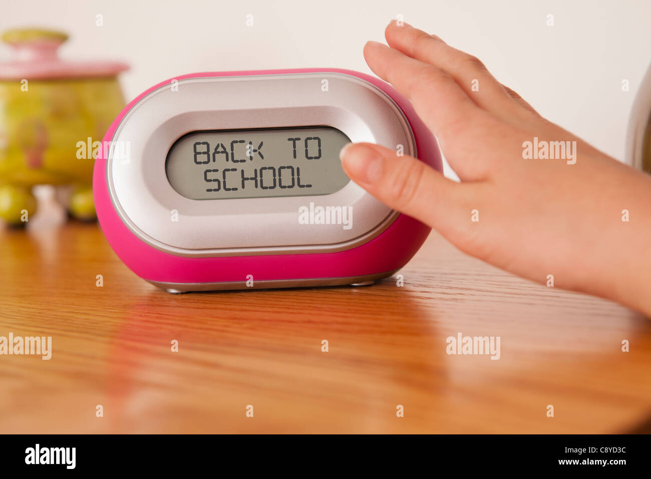 USA, Illinois, Metamora, Child's (10-11) hand pushing alarm clock Stock Photo