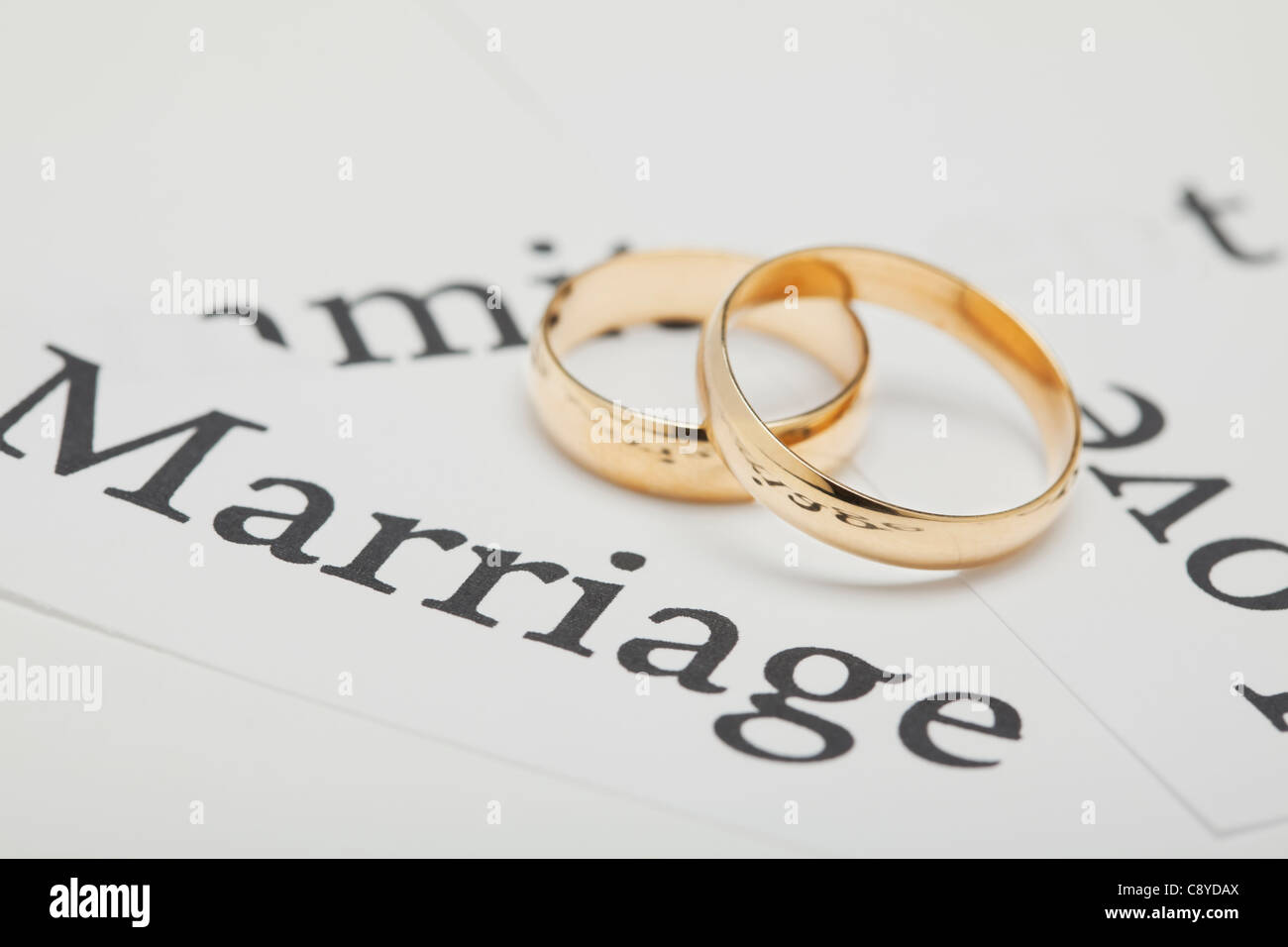USA, Illinois, Metamora, Two wedding rings on paper with words connected with wedding Stock Photo