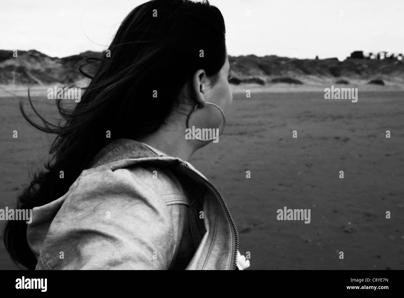 Girl turning away on beach Stock Photo - Alamy