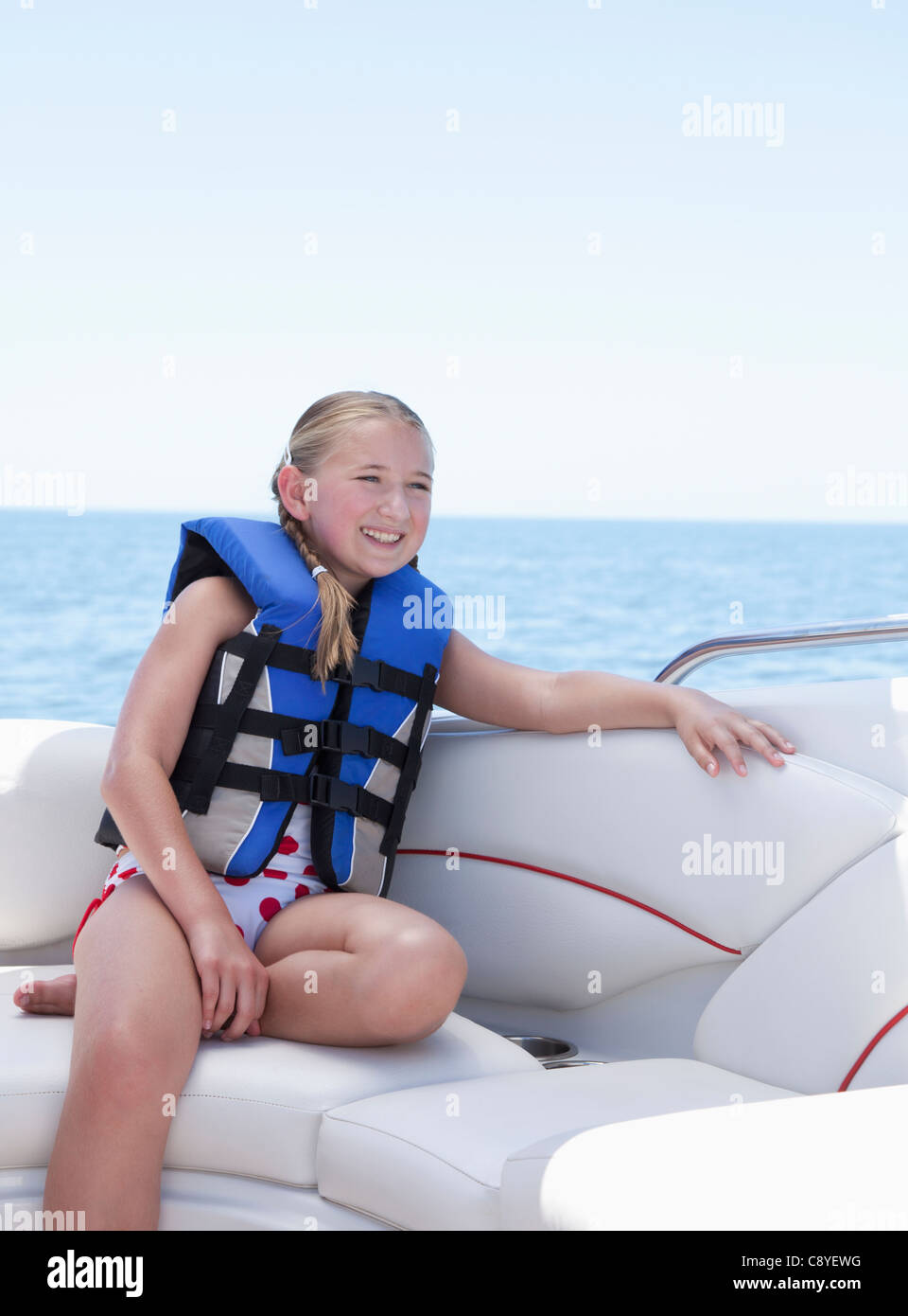 USA, Florida, St. Petersburg, Smilling girl (10-11) wearing life jacket in speedboat Stock Photo