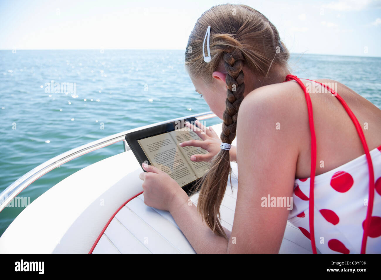 USA, Florida, St. Petersburg, Girl (10-11) using digital tablet on yacht Stock Photo