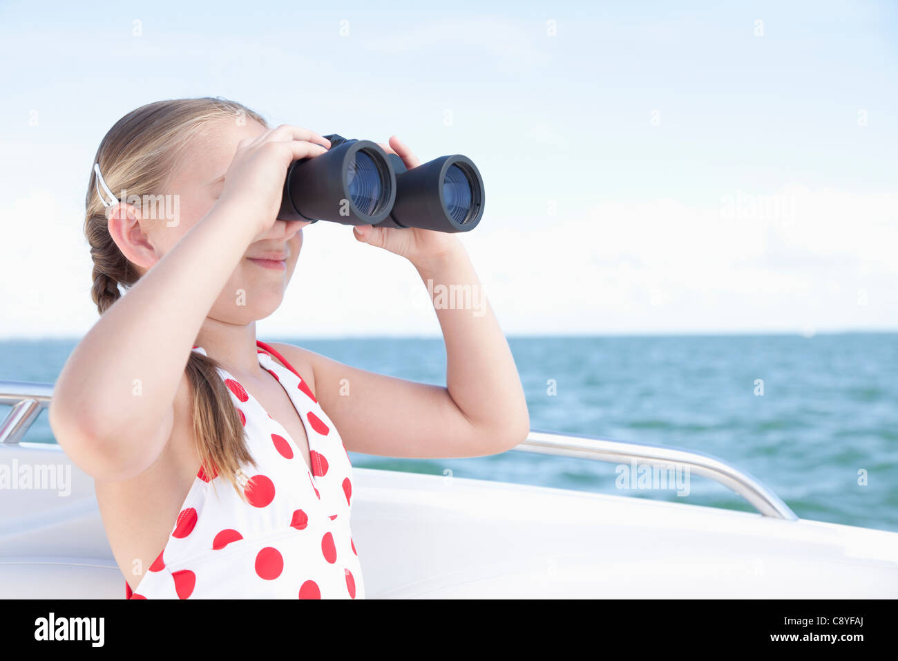 USA, Florida, St. Petersburg, Girl (10-11) on yacht looking through binoculars Stock Photo