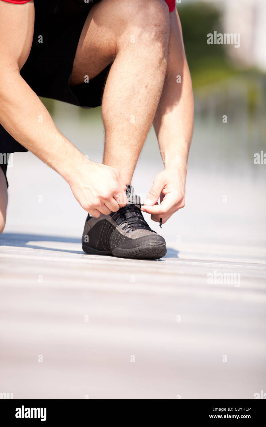 Picture of Runner tightening his shoelace Stock Photo - Alamy