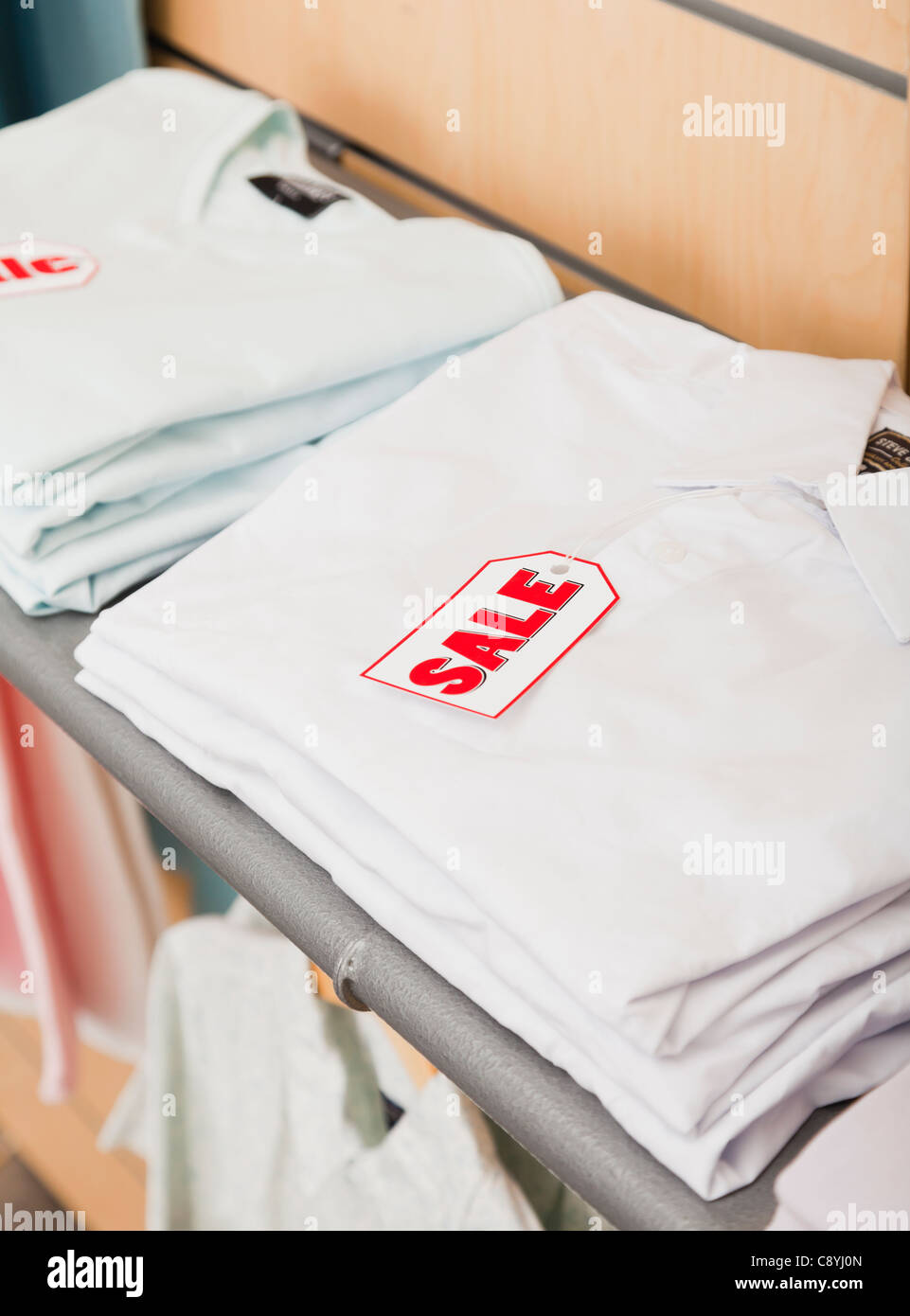 USA, Illinois, Metamora, Sale tag on folded shirts in shop Stock Photo