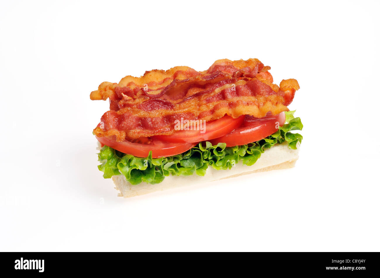 Bacon Lettuce and Tomato BLT open faced sandwich on a  bread roll on white background cutout. Stock Photo