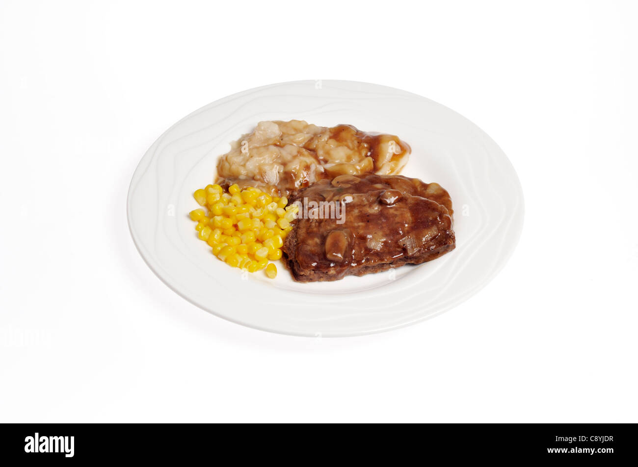 Meatloaf dinner with onion gravy, mashed potatoes and corn on white plate on white background cutout. Stock Photo