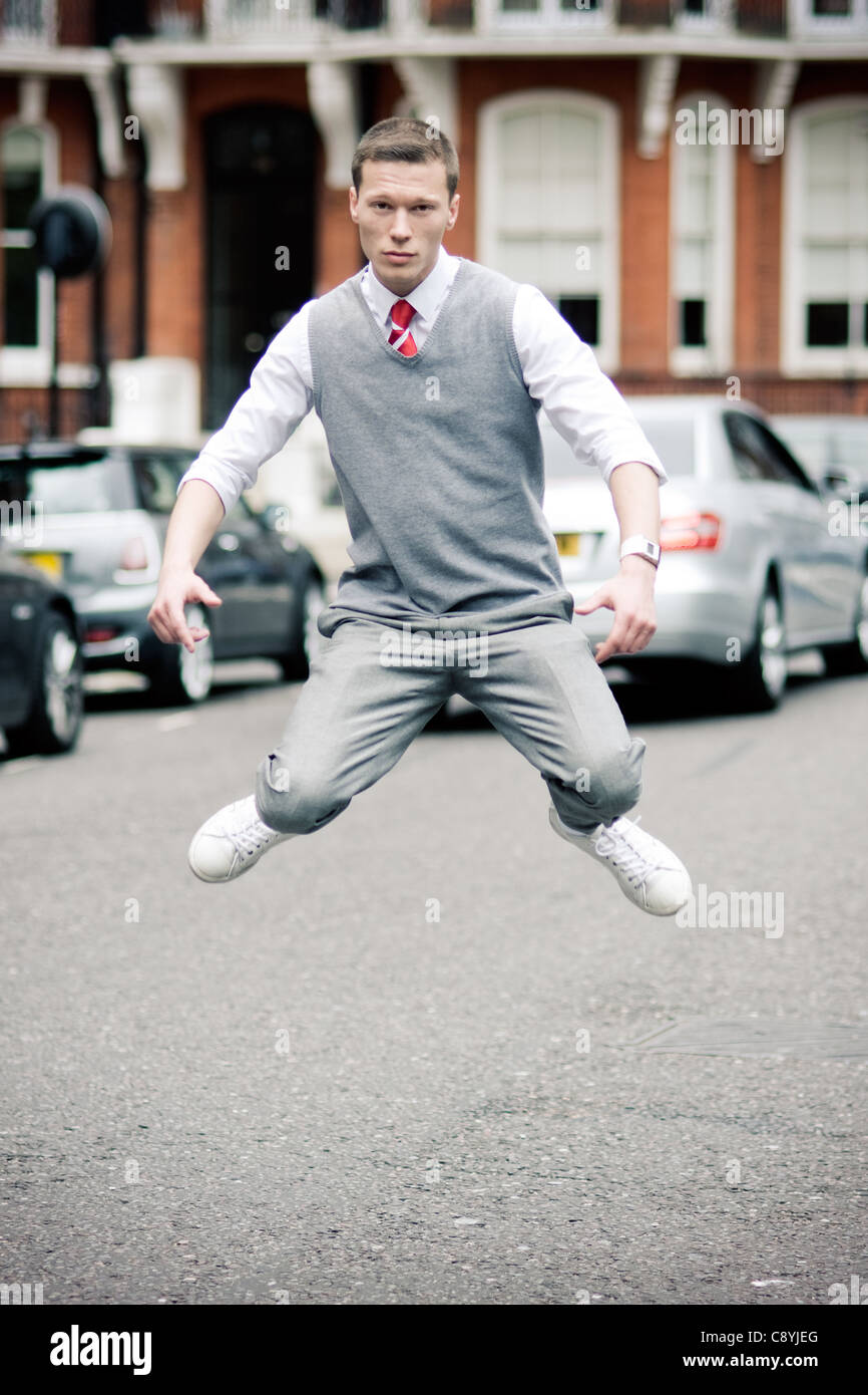 Young man from Russia dancing and jumping on the road in Chelsea Stock Photo