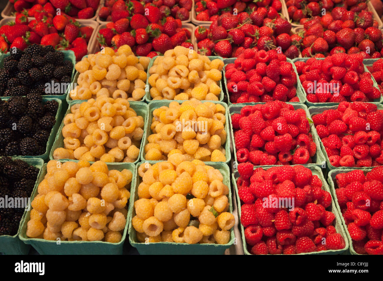 Fresh raspberry varieties in Granville Island Public Market in Vancouver, Canada. Stock Photo