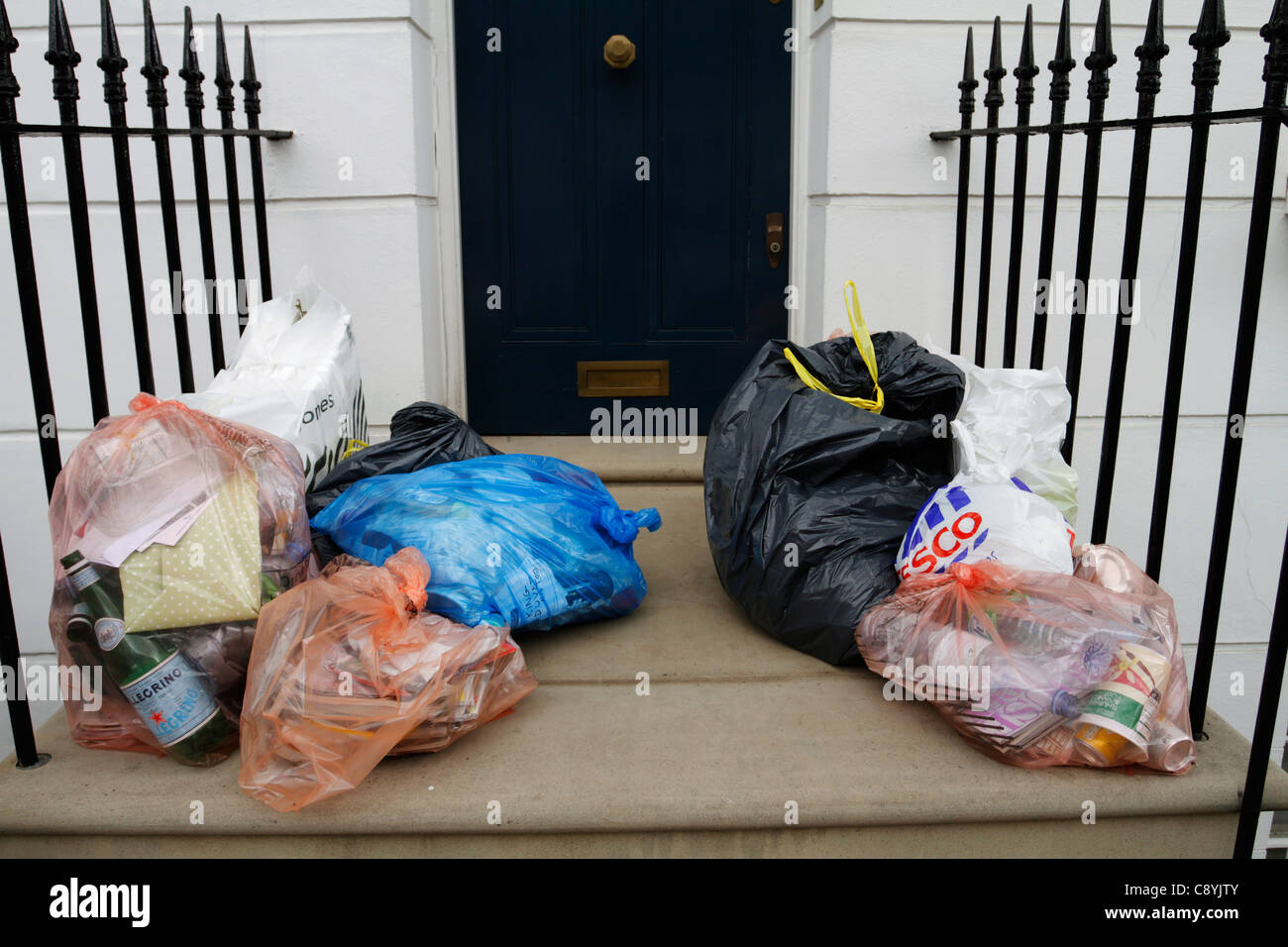 Three big blacks trash bags in front of wall Stock Photo - Alamy