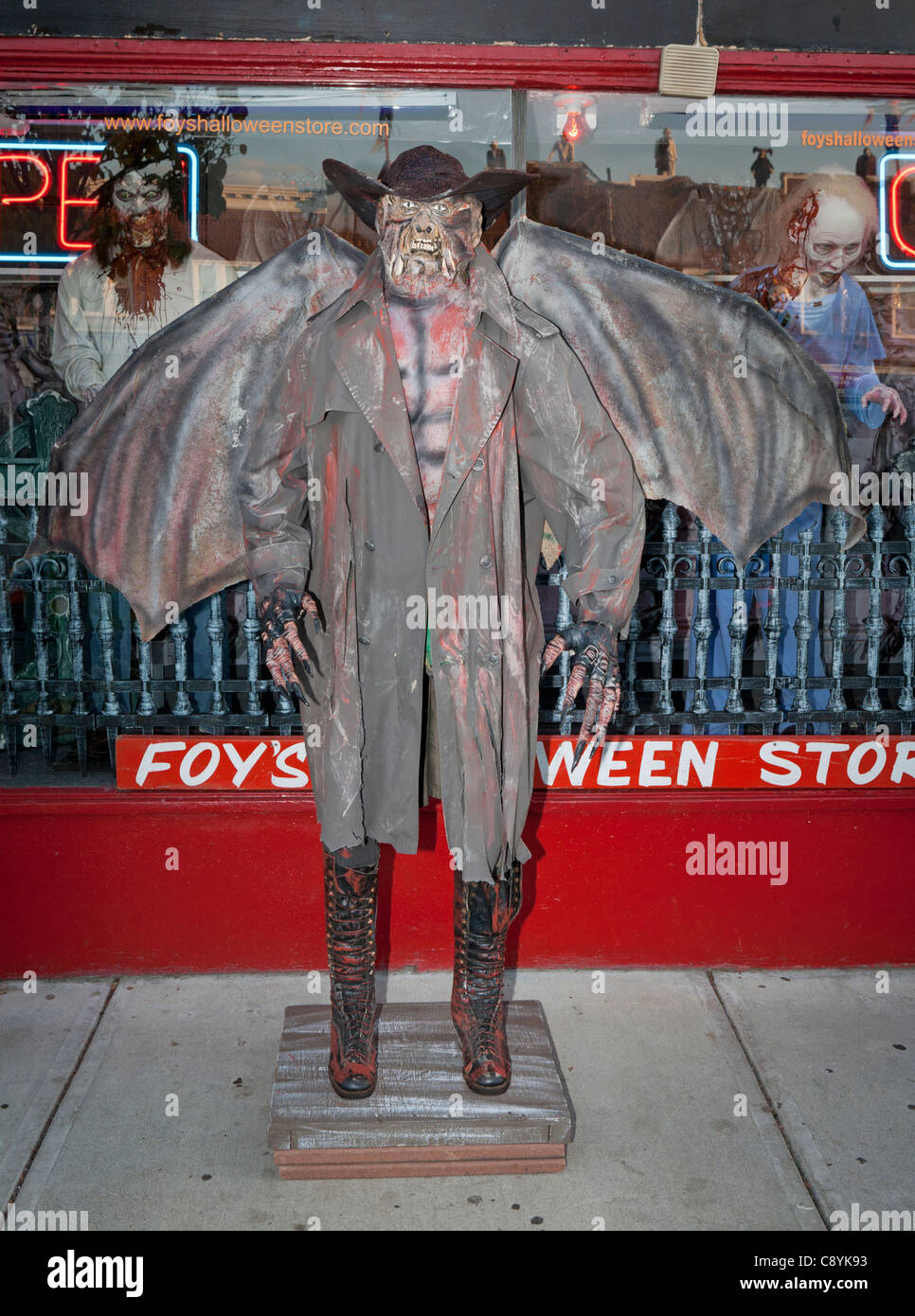 Winged demon in front of a store. Stock Photo