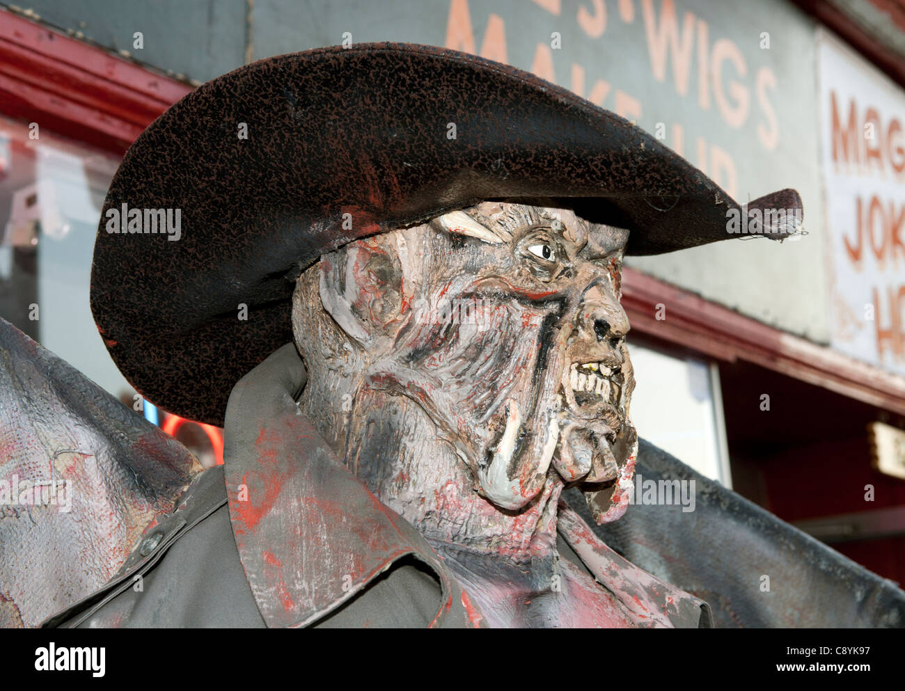 Winged demon in front of a store. Stock Photo