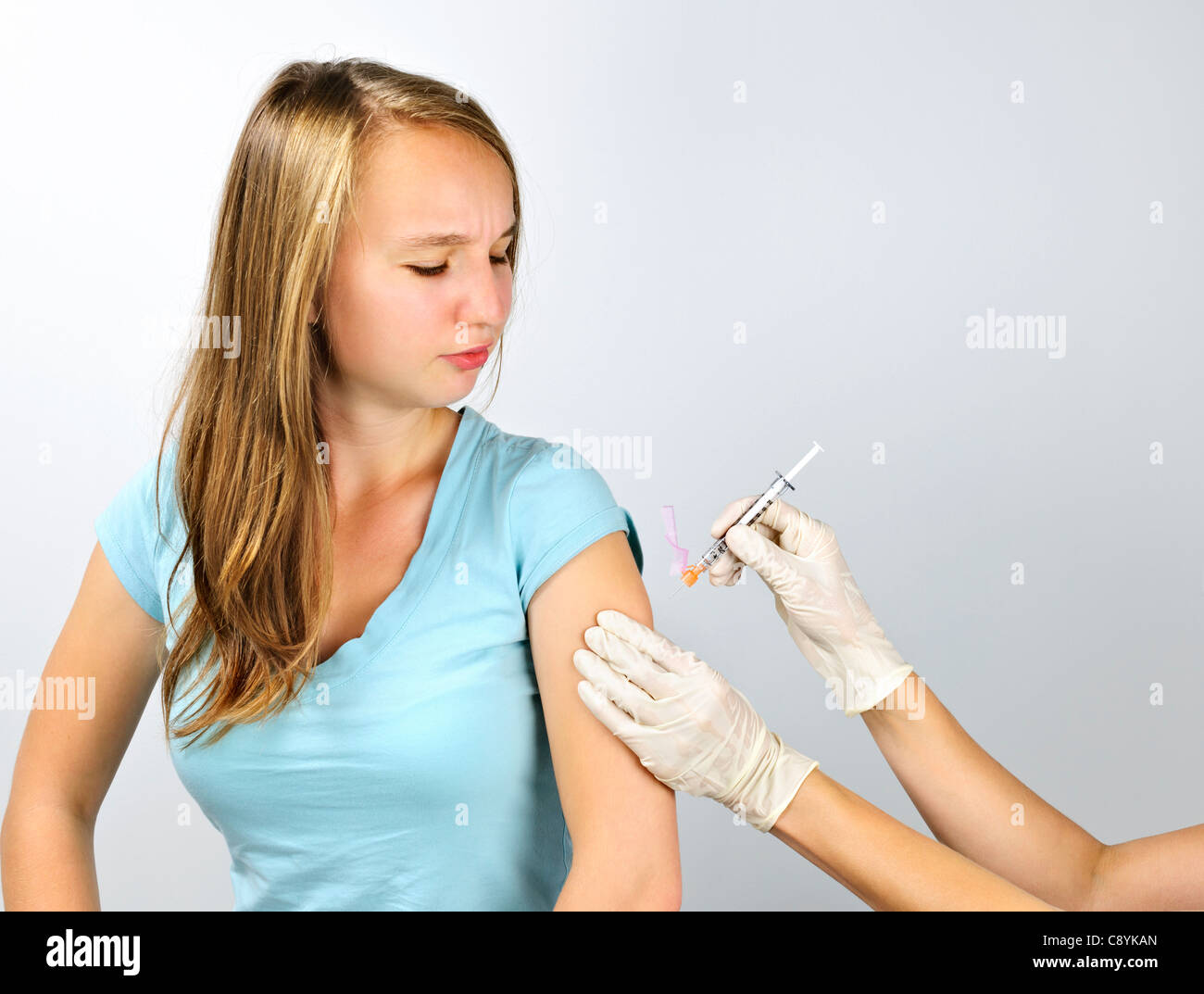 Teenage girl getting flu shot needle vaccination in arm Stock Photo Alamy