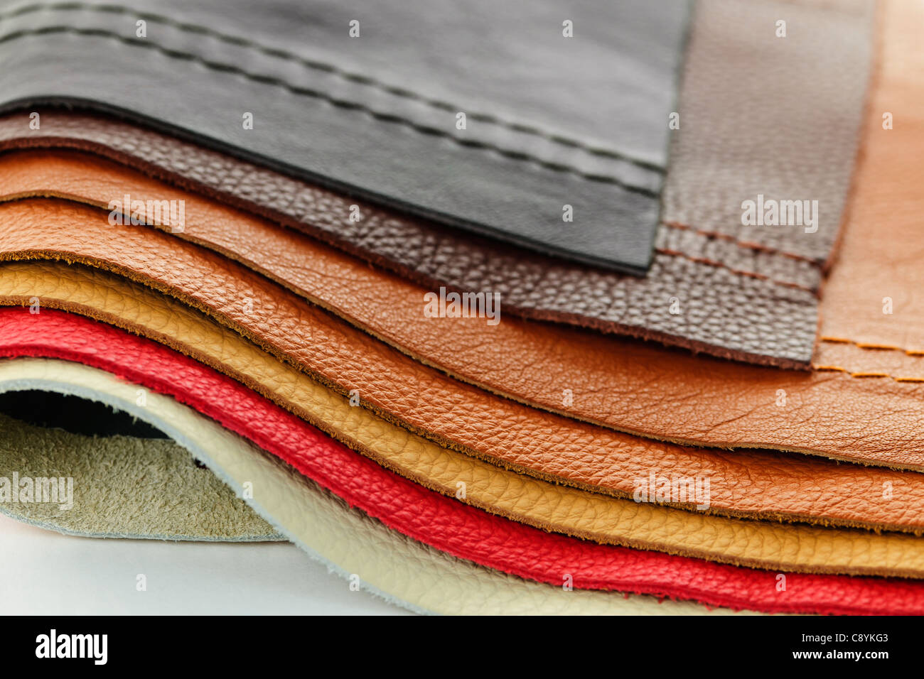 Natural leather upholstery samples with stitching in various colors Stock Photo