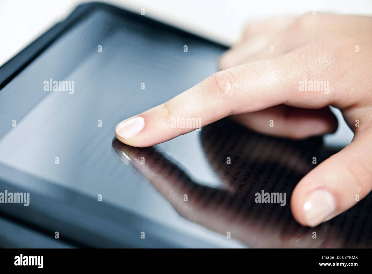 Female hand touching tablet computer screen with finger Stock Photo