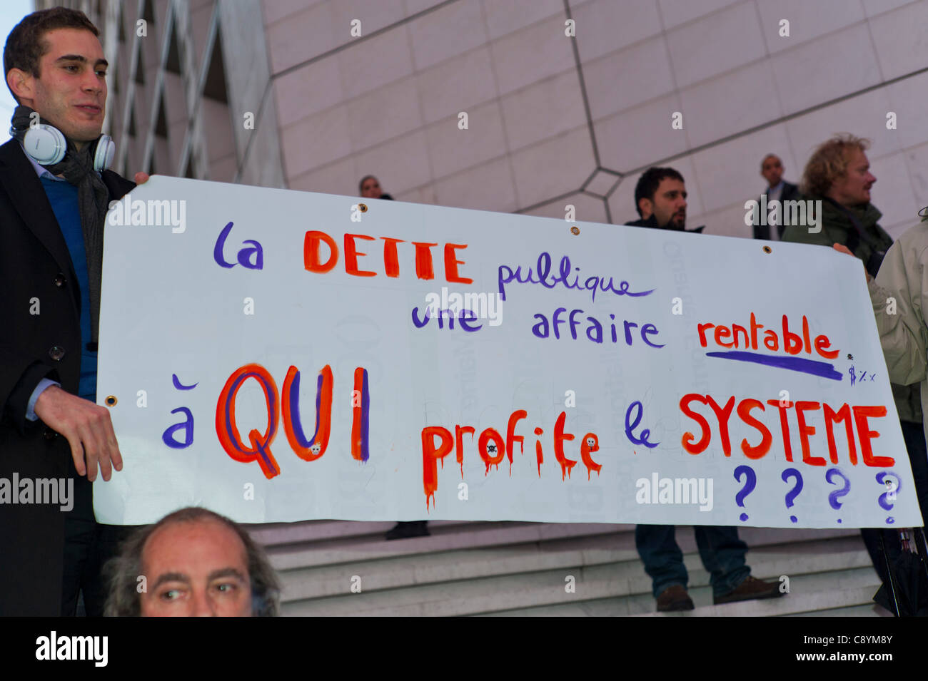 Paris, France, 'Occupy La Défense' Demonstration, Against Corporate Greed and Government Corruption, Protests, French Teenagers Holding Protest Sign, 'Public Debt; a profitable business, who profits form the system?' Stock Photo