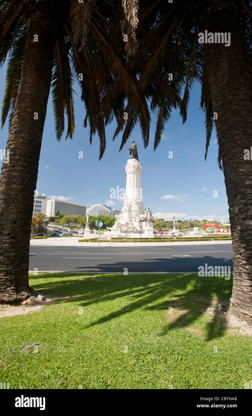 Lisbon roundabout with statue, Praca Marques de Pombal, with palm trees in foreground. Stock Photo