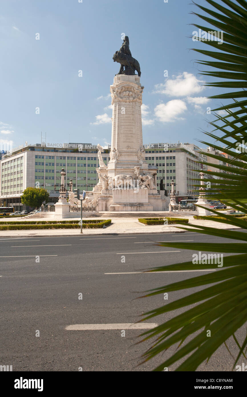 Lisbon roundabout with statue, Praca Marques de Pombal, with palm leaves in foreground. Stock Photo