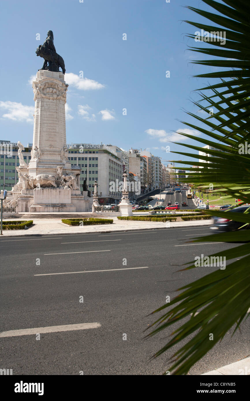 Lisbon roundabout with statue, Praca Marques de Pombal, with palm leaves in foreground. Stock Photo