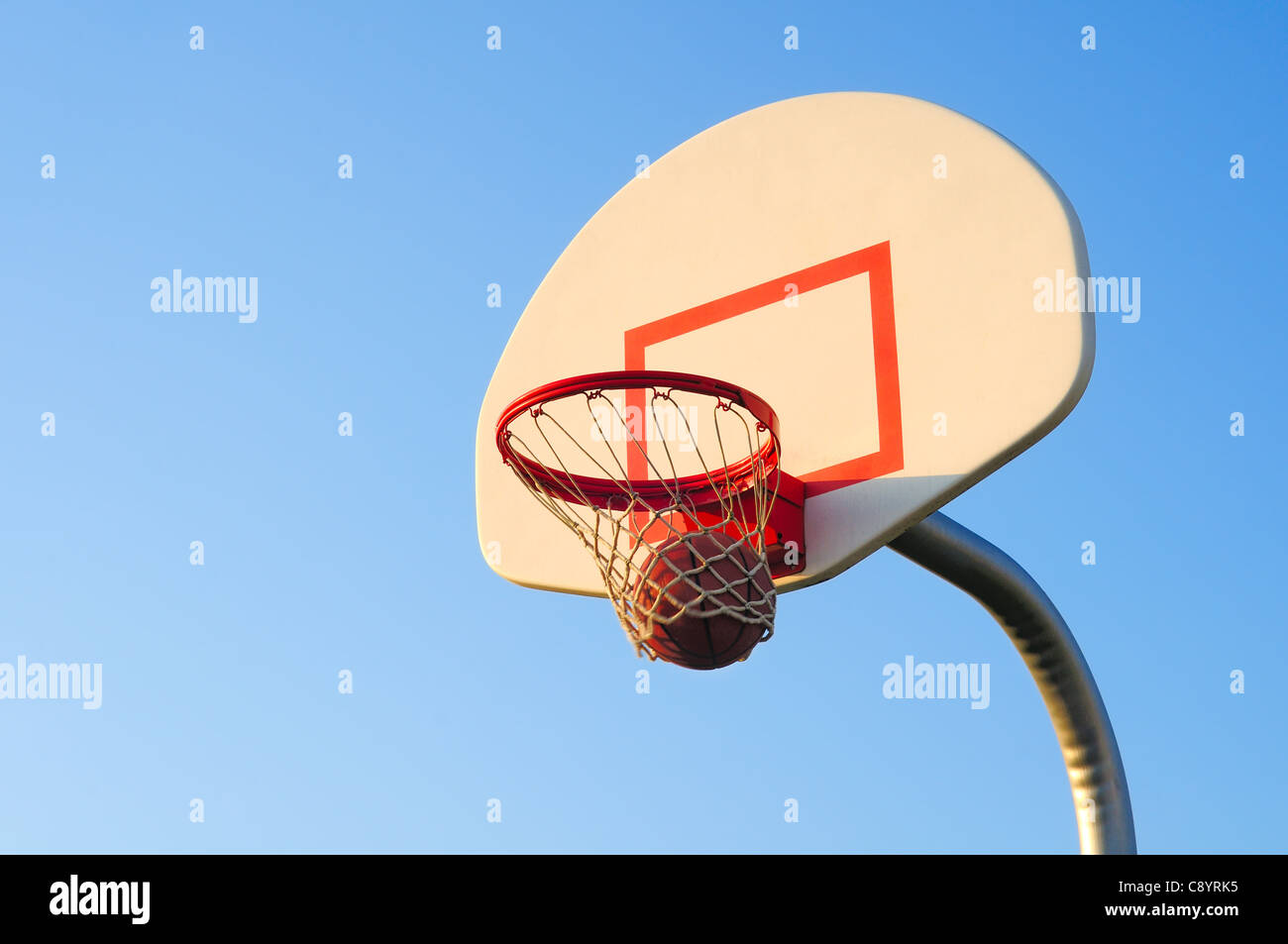 A basketball shot swishes through the net Stock Photo Alamy