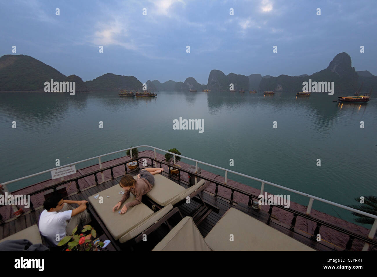 Asia, Vietnam, Halong Bay. Boat trip on the Halong Bay. Tourist junks anchoring at their overnight stop. Designated a UNESCO ... Stock Photo