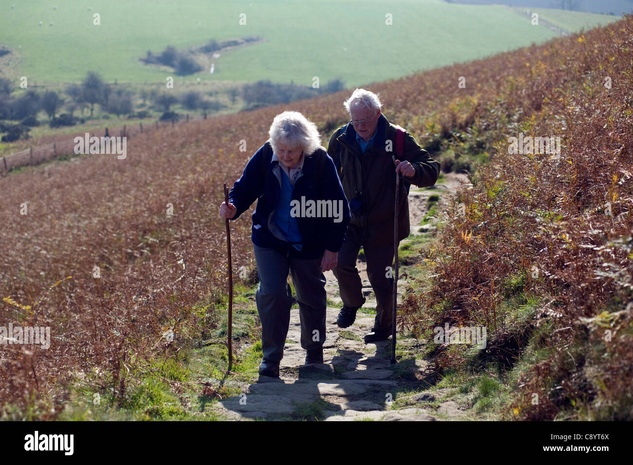 Married pensioners hiking up Roseberry Topping in north yorkshire , england Stock Photo