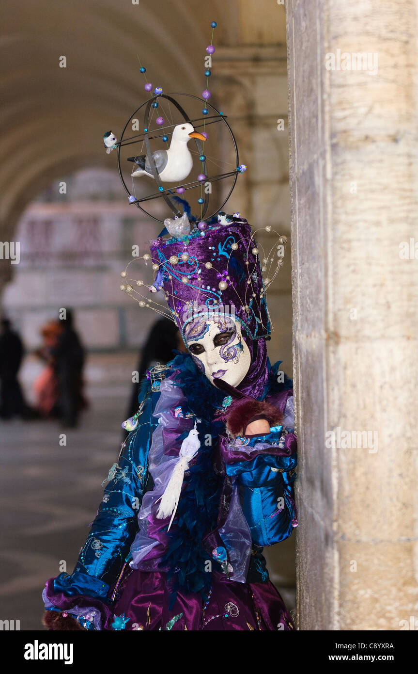 person in carnival costume posing for public at San Marco square during