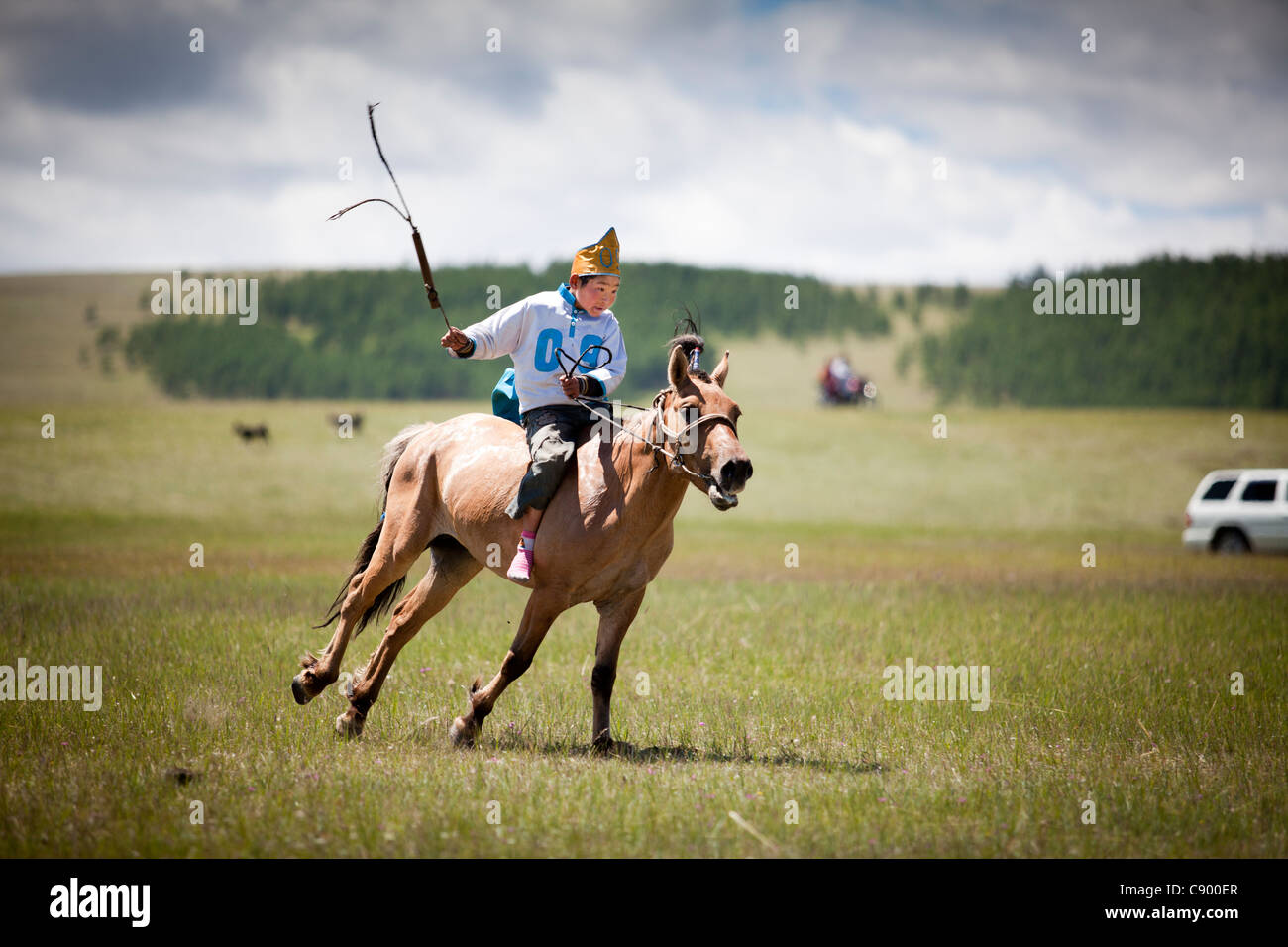 Mongolian child horse racing at Naadam festival in Tsagaannuur, Khövsgöl, Mongolia Stock Photo